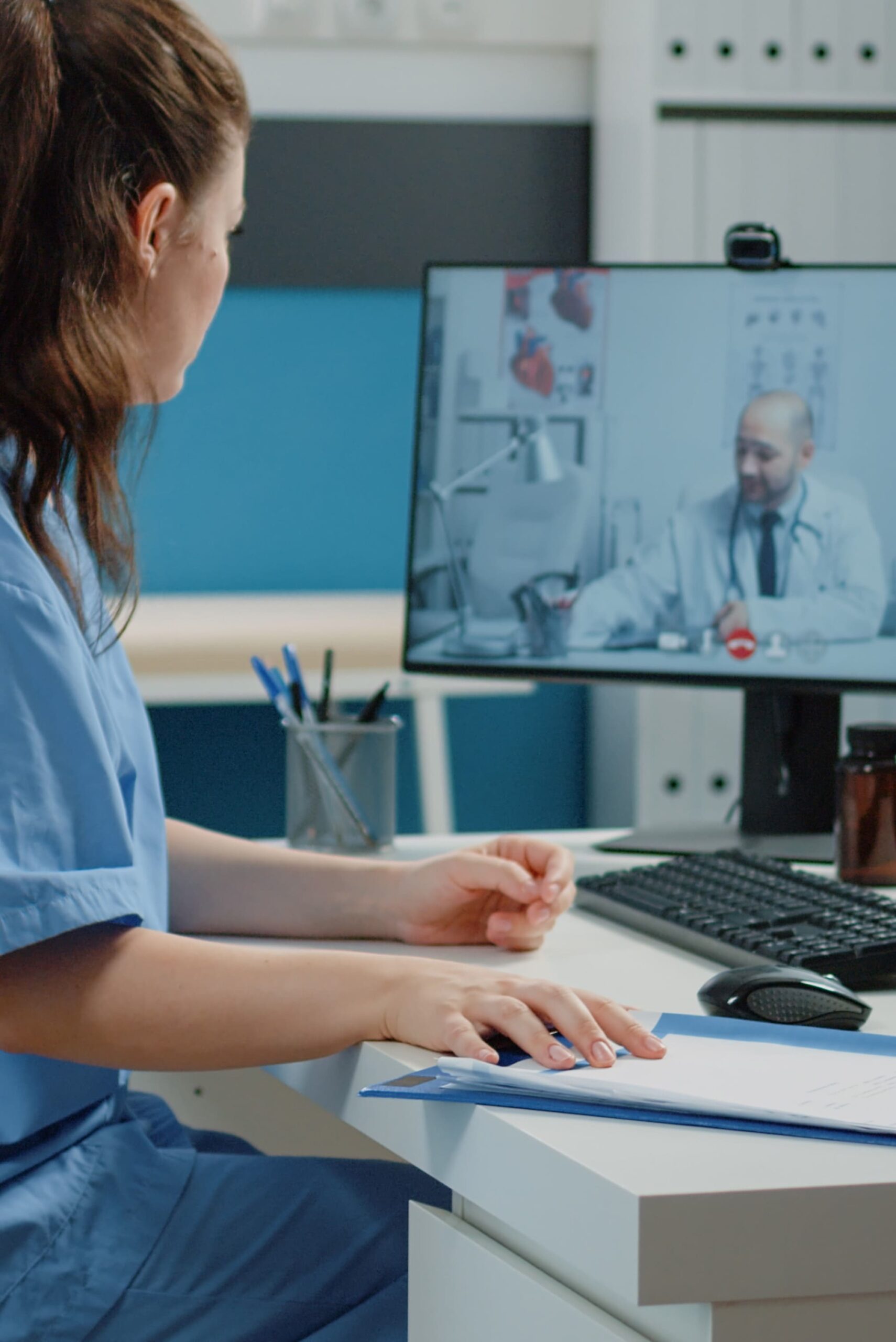 nurse-talking-doctor-video-call-professional-advice-cabinet-medical-assistant-using-online-conference-with-specialist-consultation-checkup-visit-healthcare-system (1)